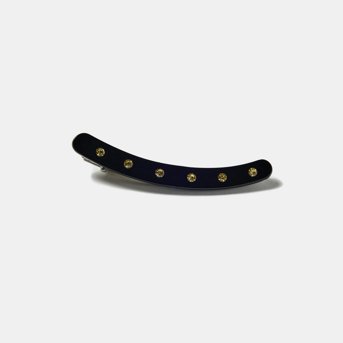 Black clip with white rhinestones on a white background
