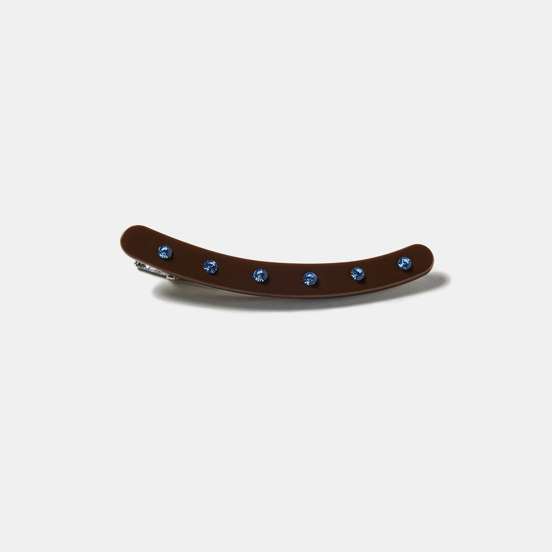 Brown clip with blue rhinestones on a white background