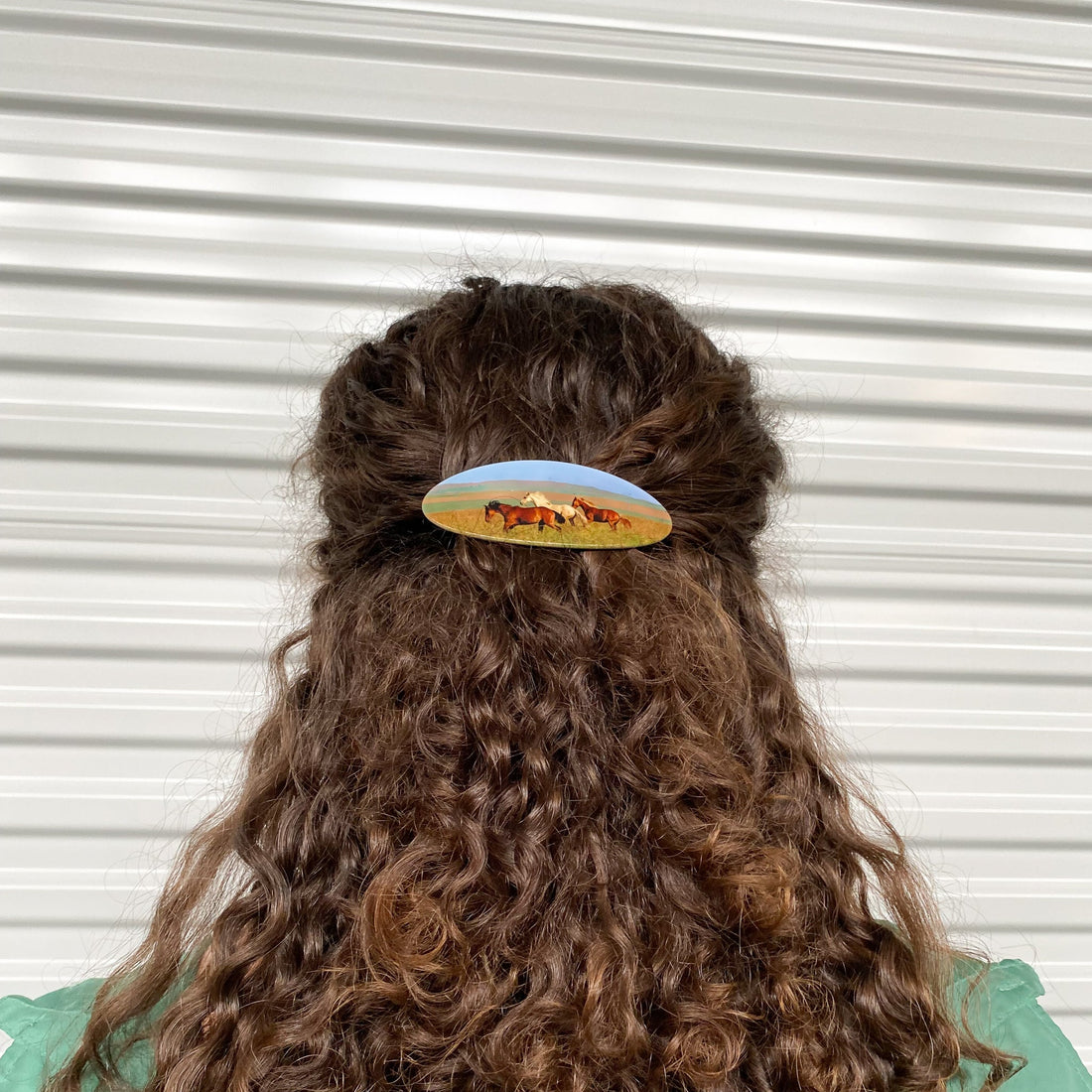 Hair barrette with printed horses on a white background