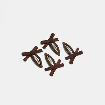 Four brown bow snap hair clips on a white background.