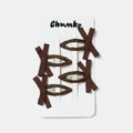Four brown bow snap hairclips clipped on a white packaging.