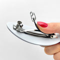 Hand unclasping a barrette.