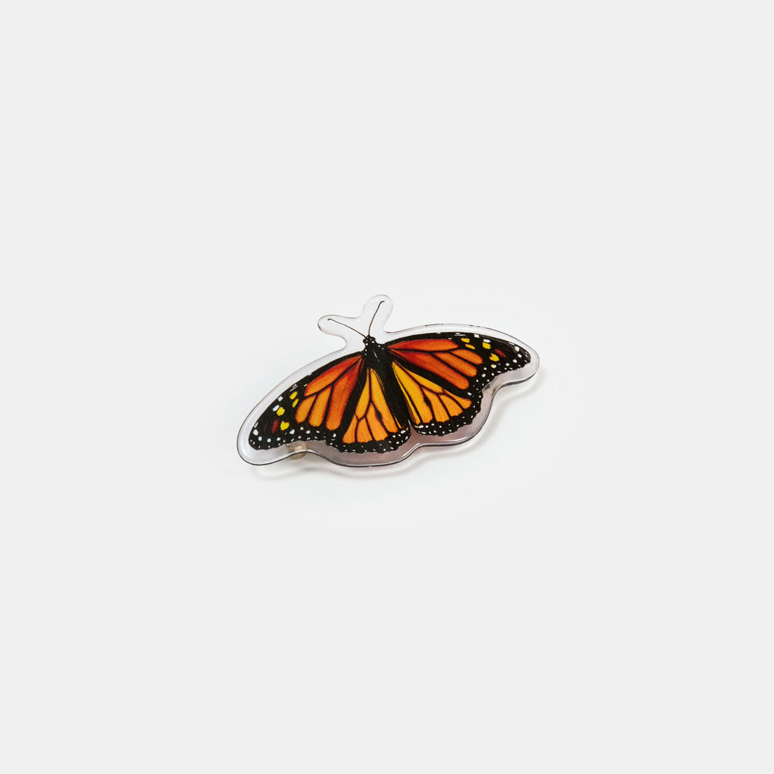Hair clasp with black and orange butterfly print design on a white background