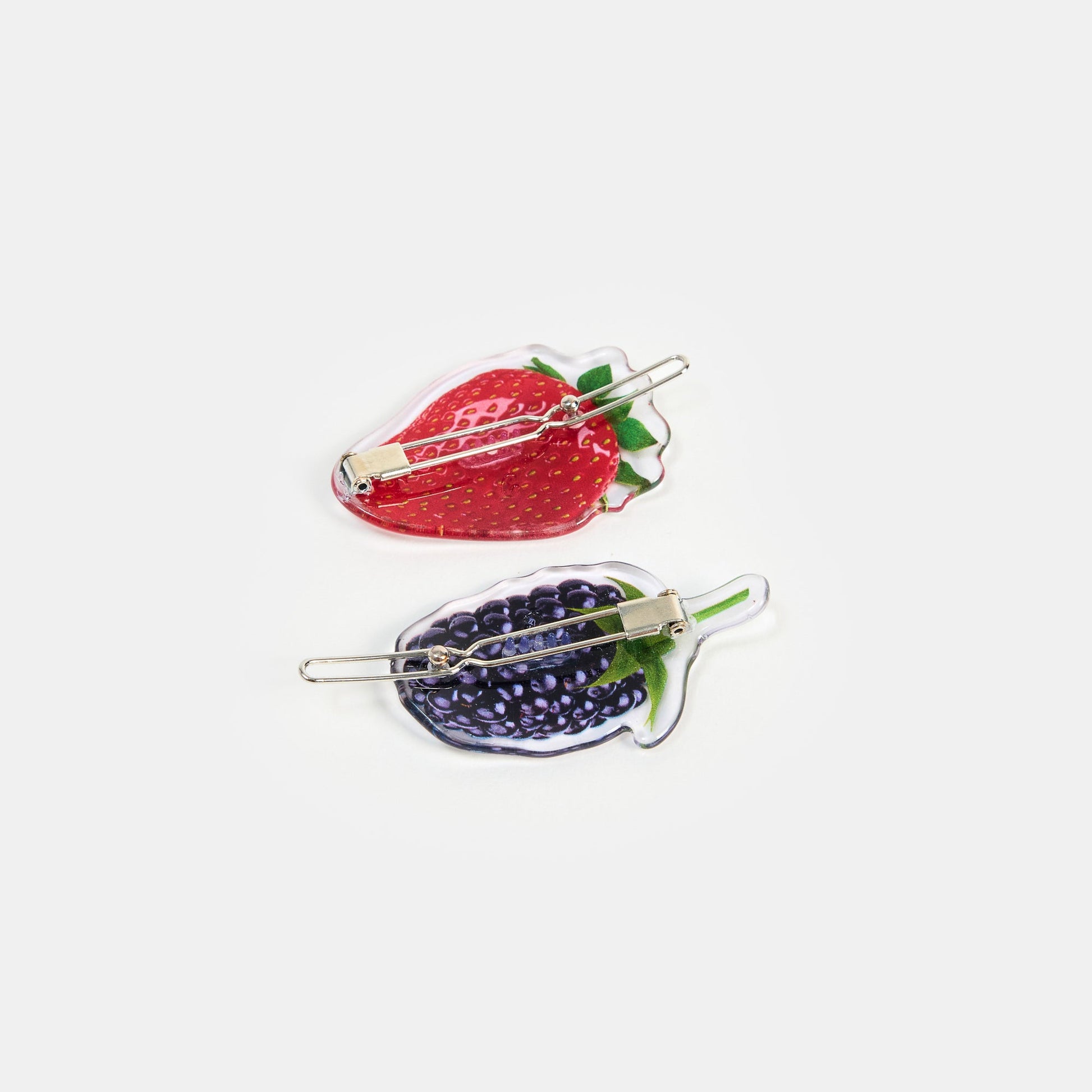Hair clasp with strawberry and blueberry print design on a white background.