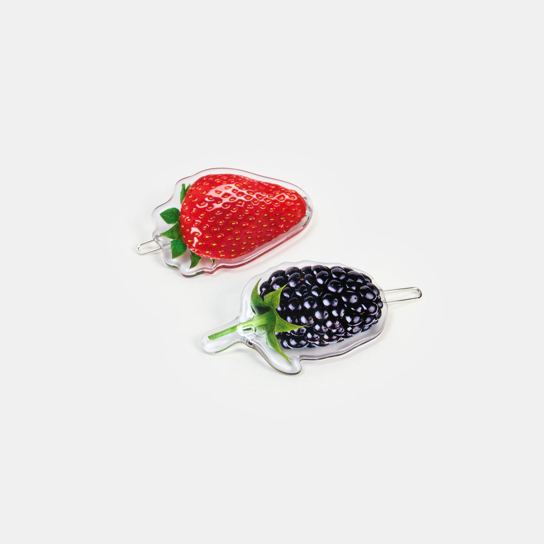 Hair clasp with strawberry and blueberry print design on a white background.