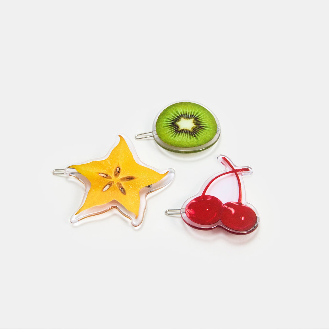 Hair clasps with kiwi, starfruit and cherries print design on a white background