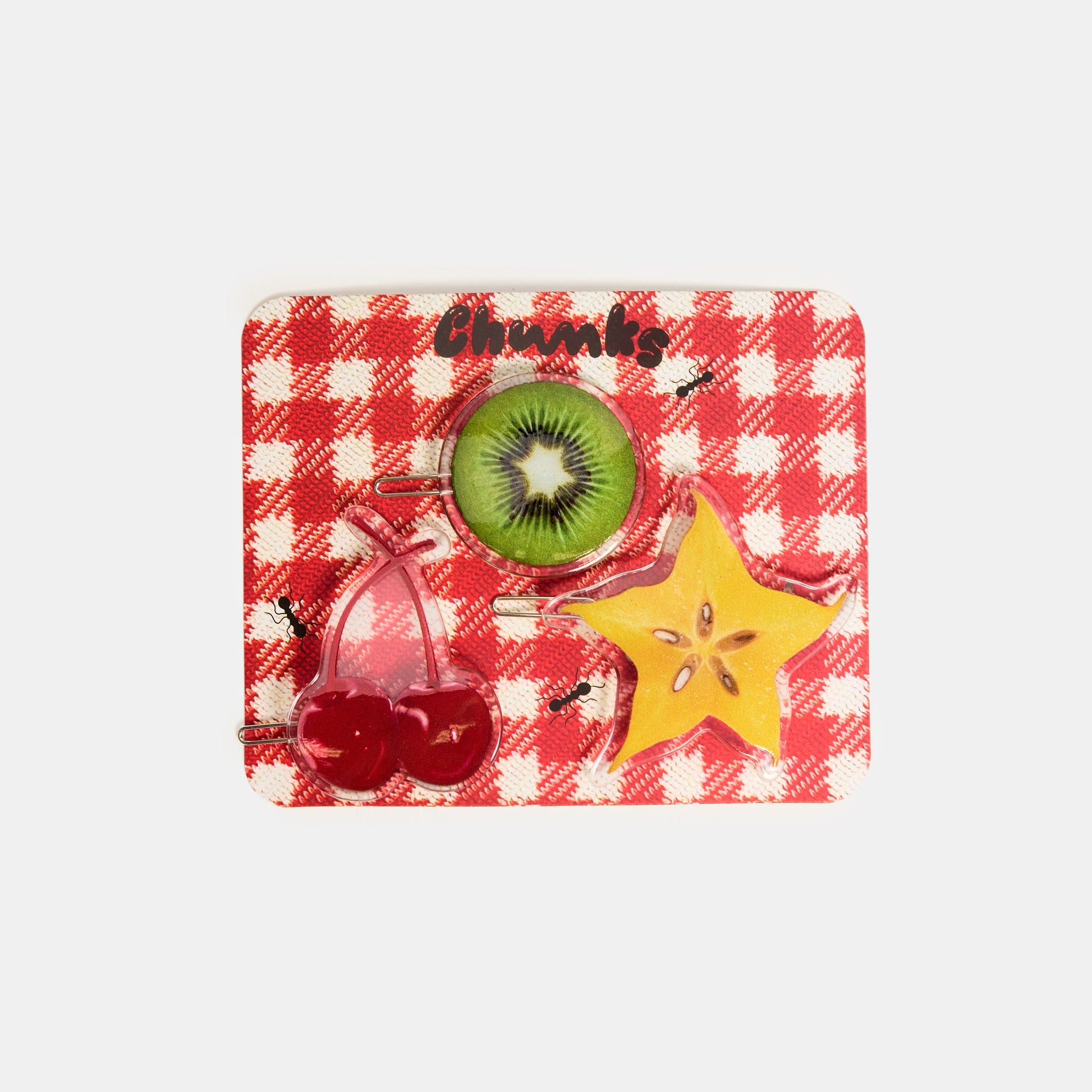 Hair clasps with kiwi, starfruit and cherries print design on a red packaging card