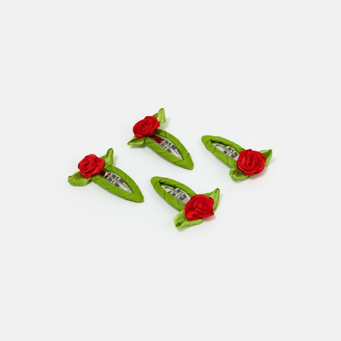 Four red and green snap clips with rosette design on a white background.